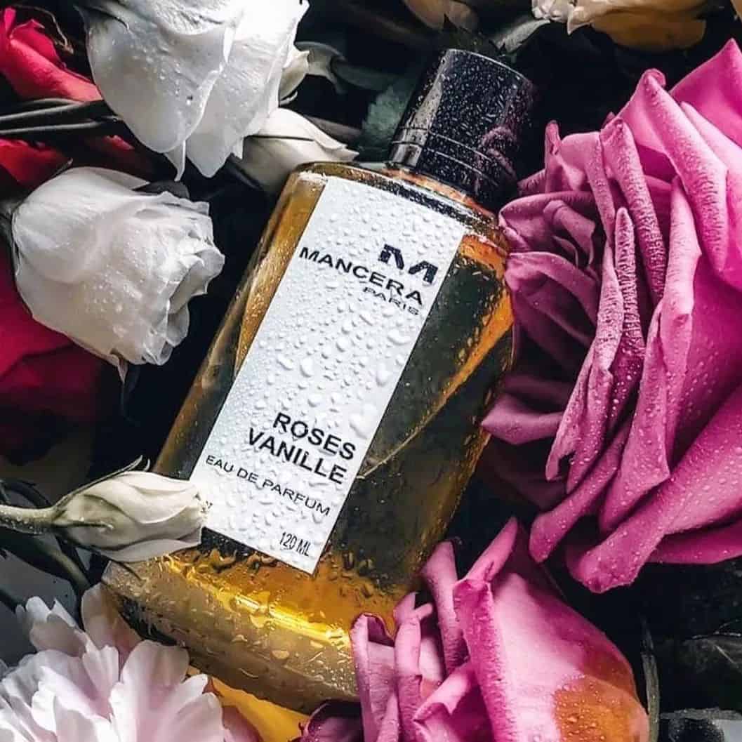 a bottle of mancera roses vanille cologne surrounded by flowers