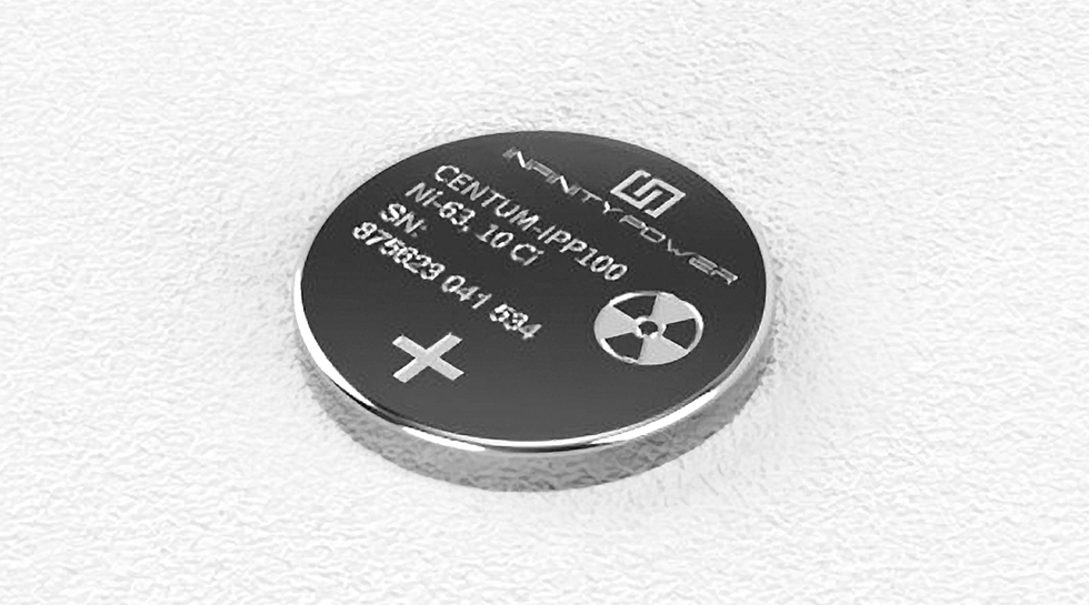 A coin-shaped metal object displaying a radioactive symbol and other details about its contents 