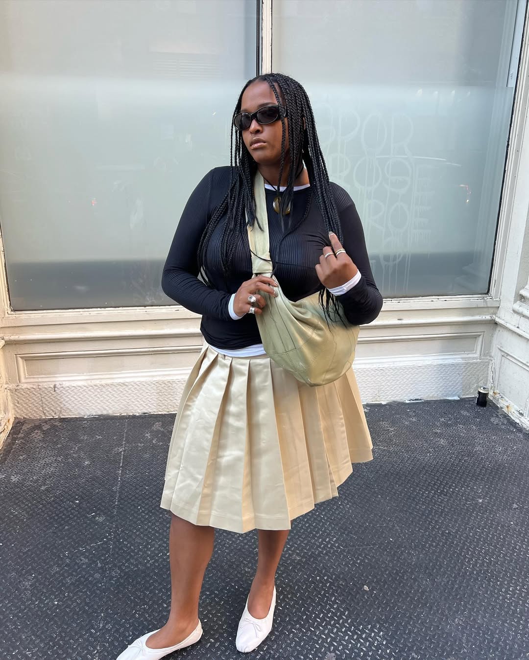 Knee length skirt outfits - pleated skirt and black cardigan