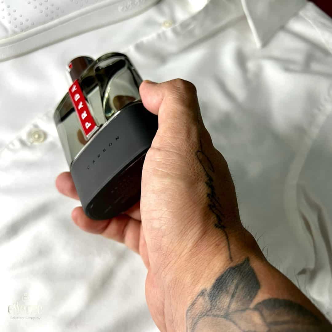 picking up a bottle of luna rossa carbon by prada