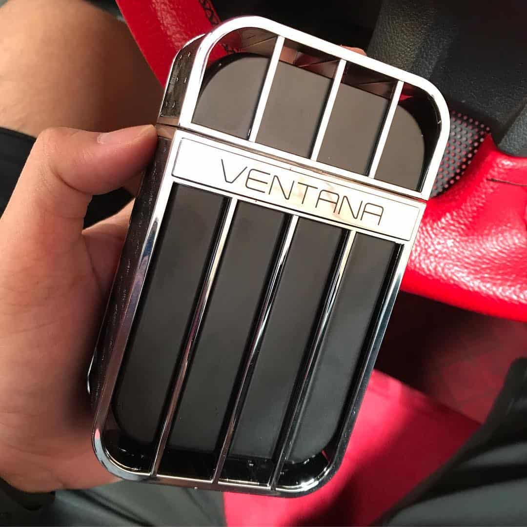 holding a bottle of ventana pour homme by armaf