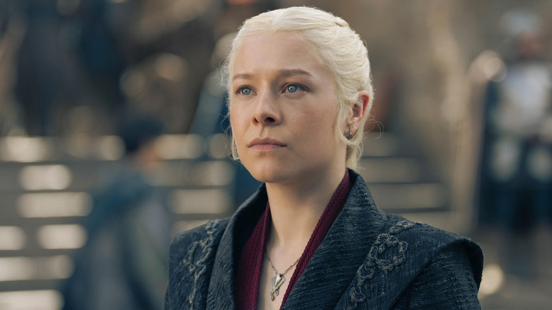 Rhaenyra Targaryen (Emma D'Arcy) pursing her lips while wearing an ornamented black coat on House of the Dragon
