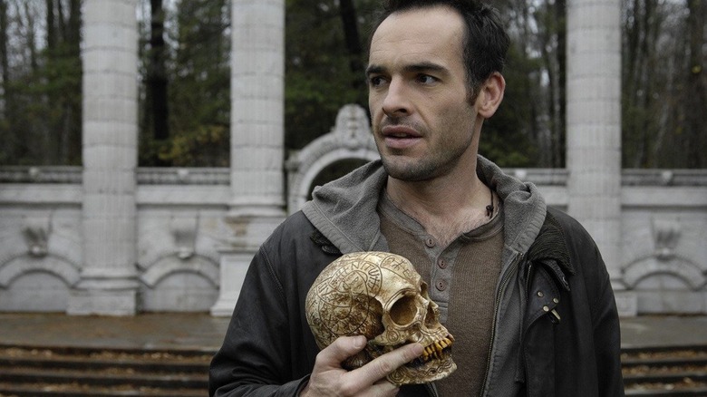 Paul Blackthorne's Harry Dresden holds Bob, the haunted skull, on The Dresden Files.